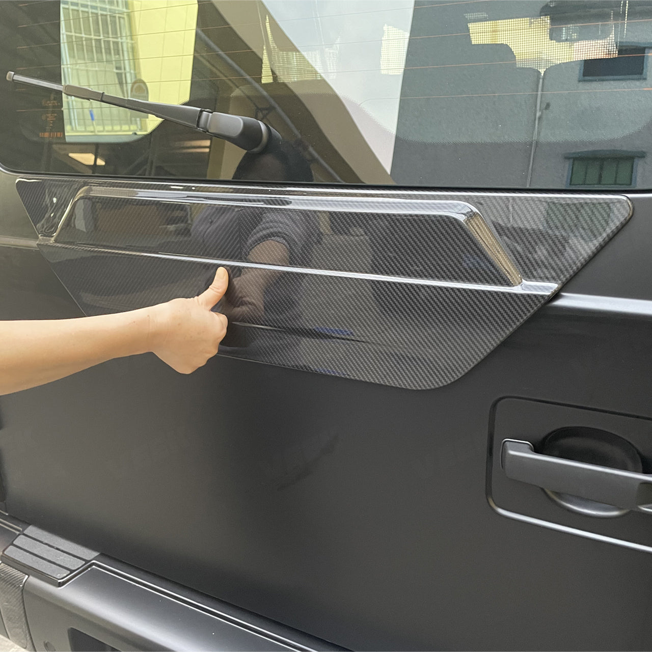 Performance-style carbon fiber tire cover for G-Class